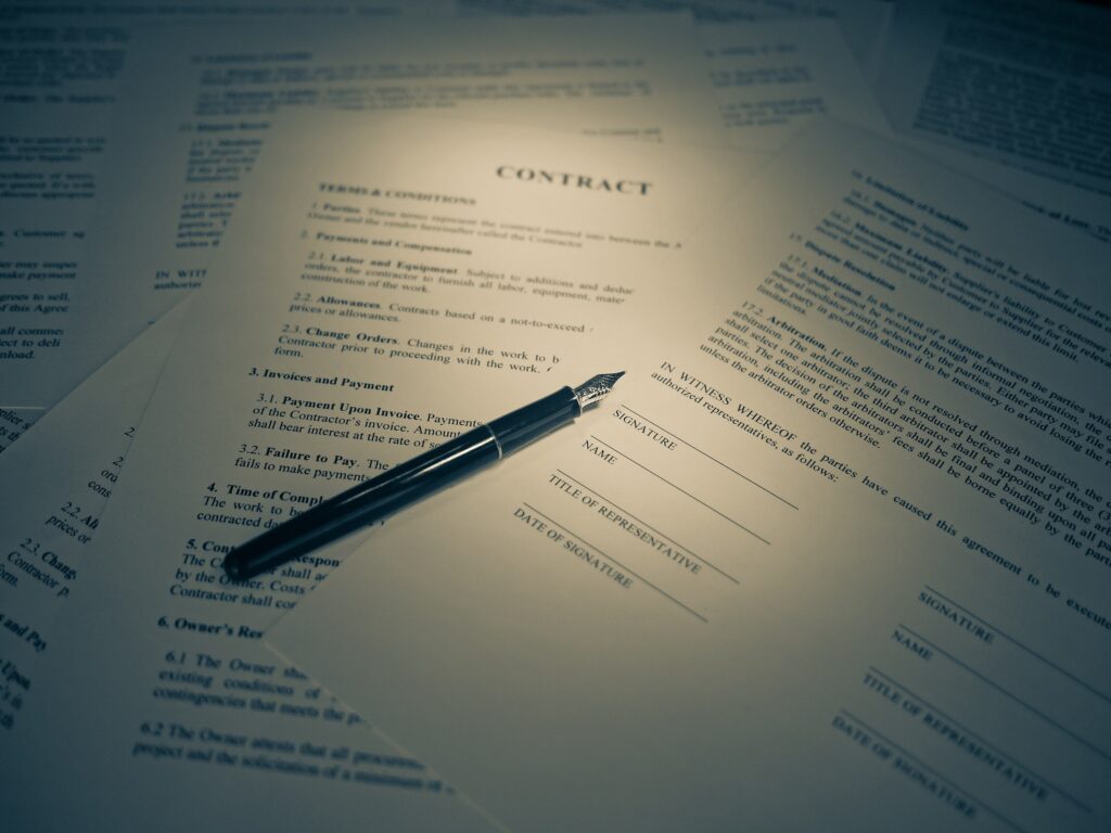 Close-up of a legal contract and a pen in warm tones