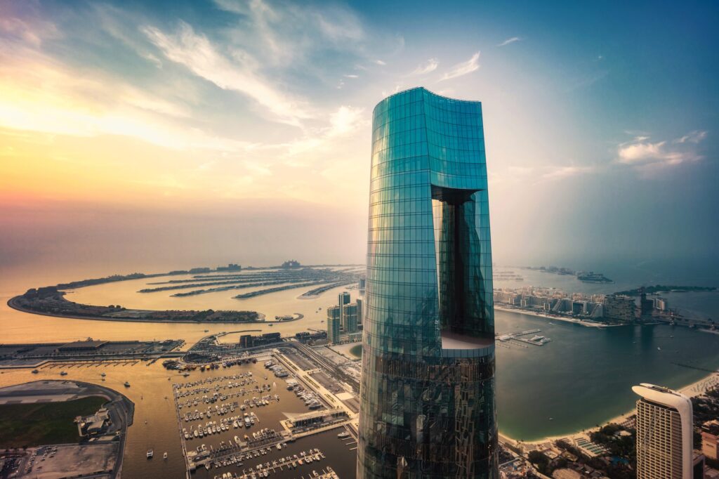 Ciel Dubai Marina, the world's tallest hotel, a glass tower rising above Dubai Marina with Palm Jumeirah behind it at sunset
