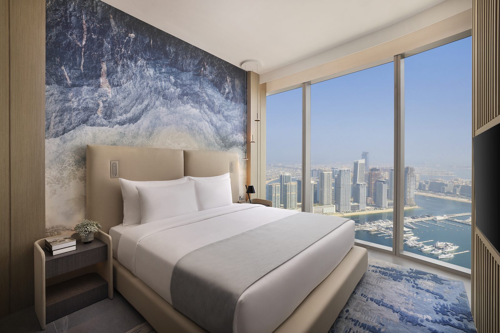 A King Premium Sea View guestroom at Ciel Dubai Marina with floor-to-ceiling windows overlooking Dubai Marina towers and the water