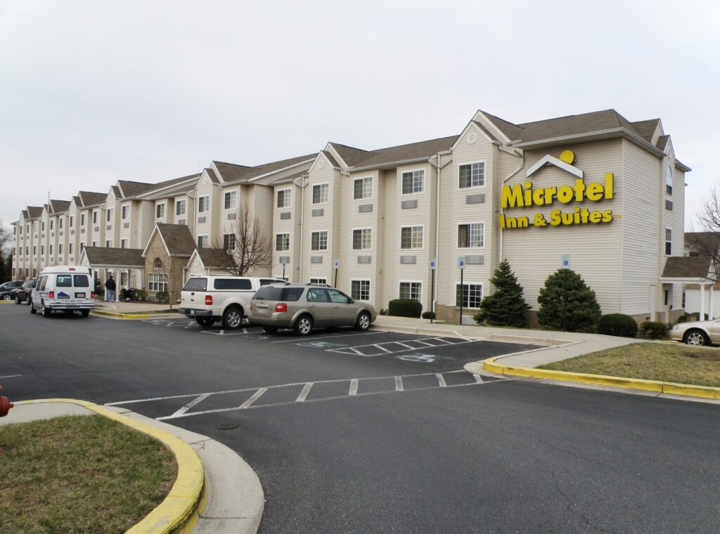 A Microtel Inn & Suites exterior with pickup trucks in the parking lot