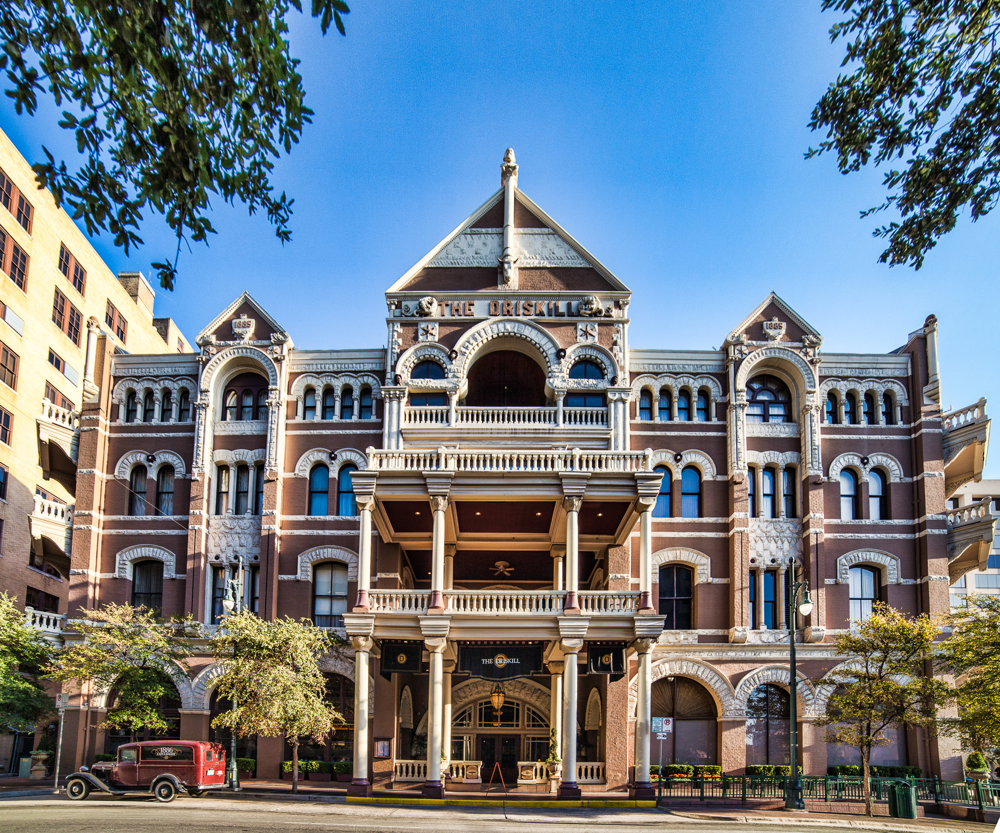 Exterior of the Driskill Hotel in downtown Austin, Texas, a Romanesque Revival building with arched windows