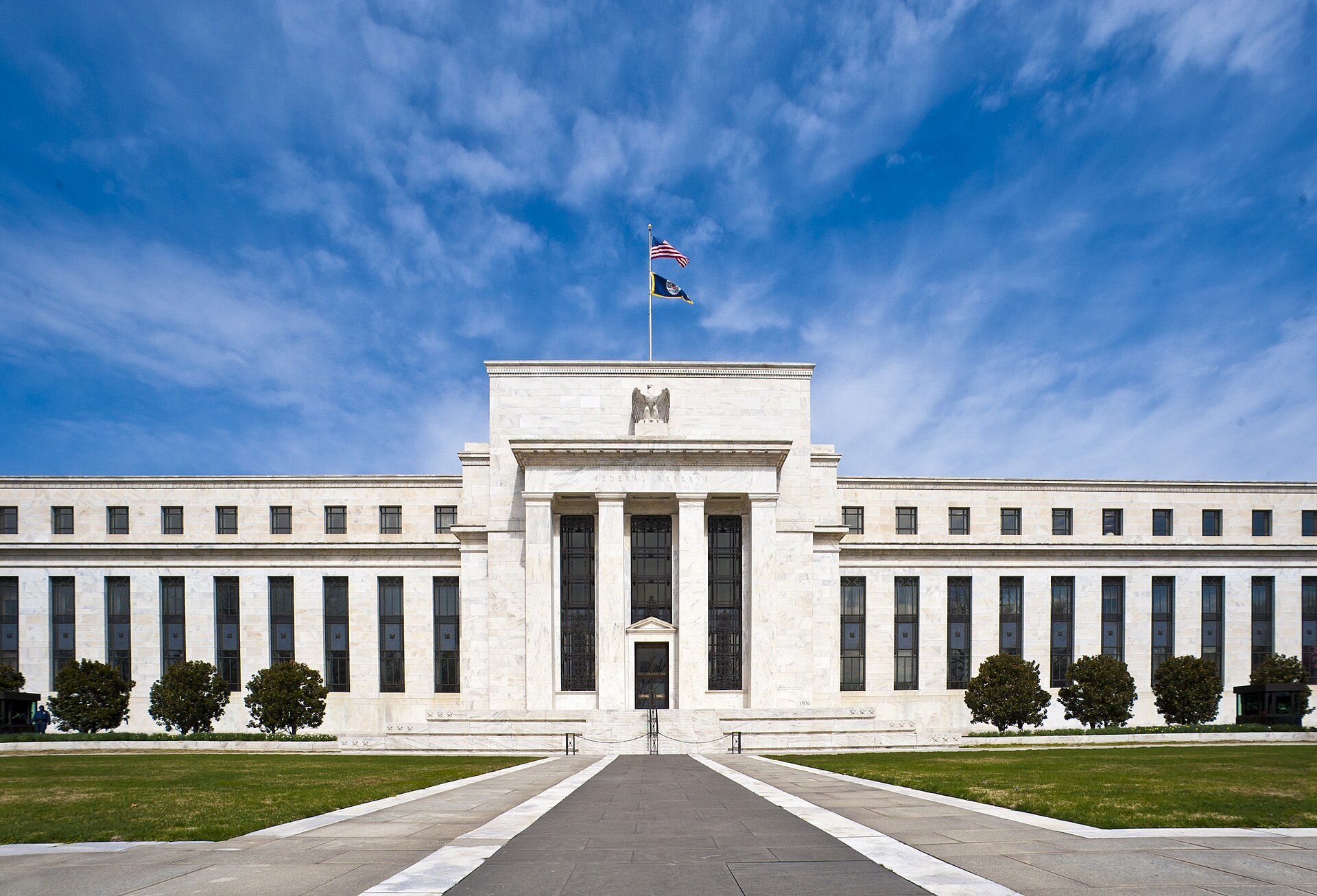 The Marriner S. Eccles Federal Reserve Board Building in Washington, D.C., under a blue sky