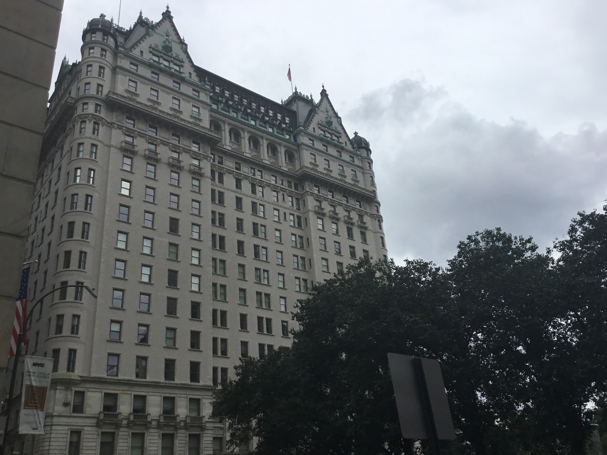 The Plaza Hotel in Manhattan seen from below, with trees in the foreground