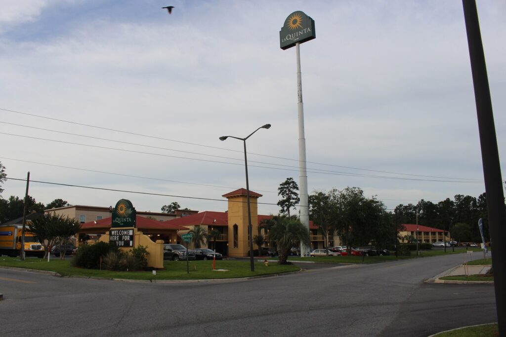 La Quinta Inn exterior and parking lot in Savannah, Georgia, under an overcast sky