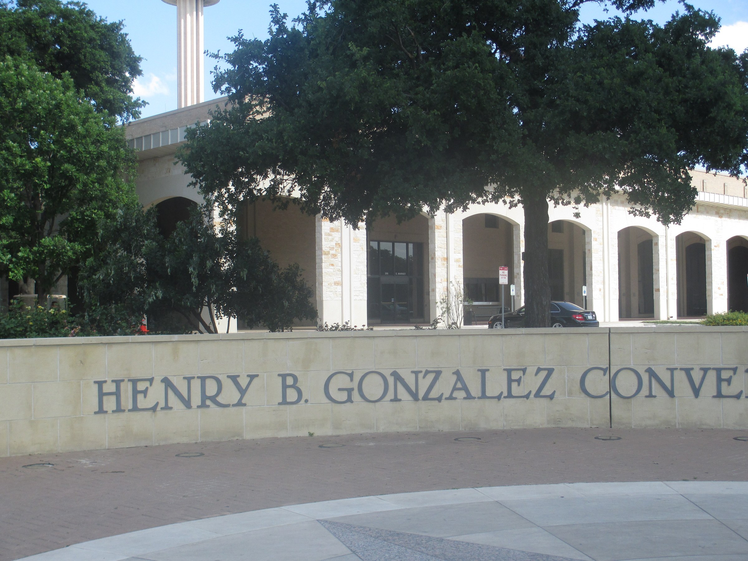 Henry B. Gonzalez Convention Center entrance sign under trees in downtown San Antonio